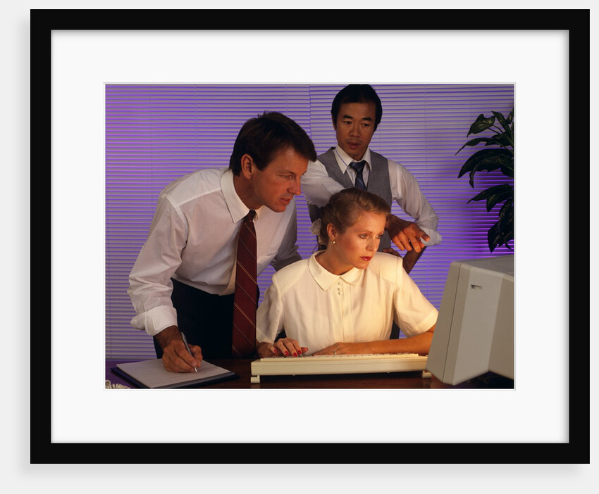 Business people working together at desktop computer by Anonymous