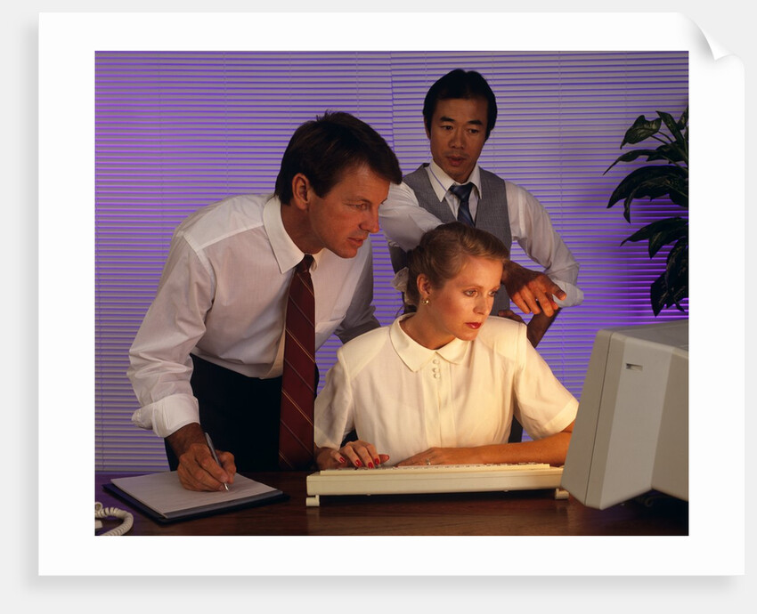 Business people working together at desktop computer by Anonymous