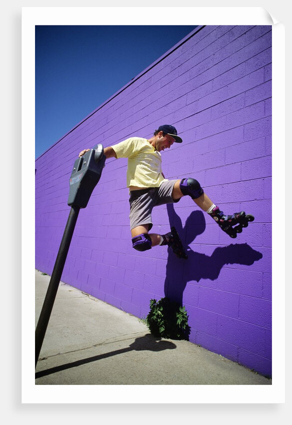 Boy Wearing Roller Blades Jumping Against Wall by Anonymous