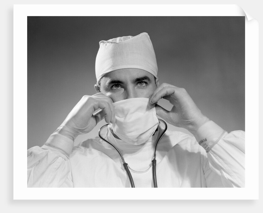 1960s male doctor wearing surgical mask and operating room scrubs by Anonymous