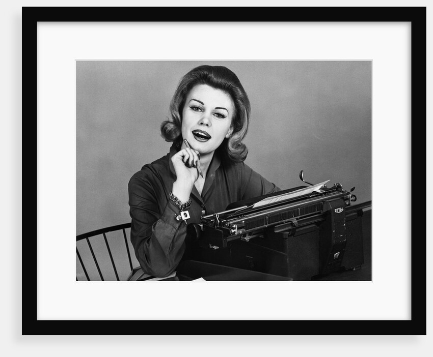 1960s smiling secretary with a typewriter by Anonymous