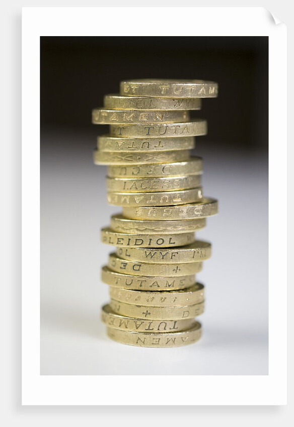 A pile of pound coins on a table by Anonymous