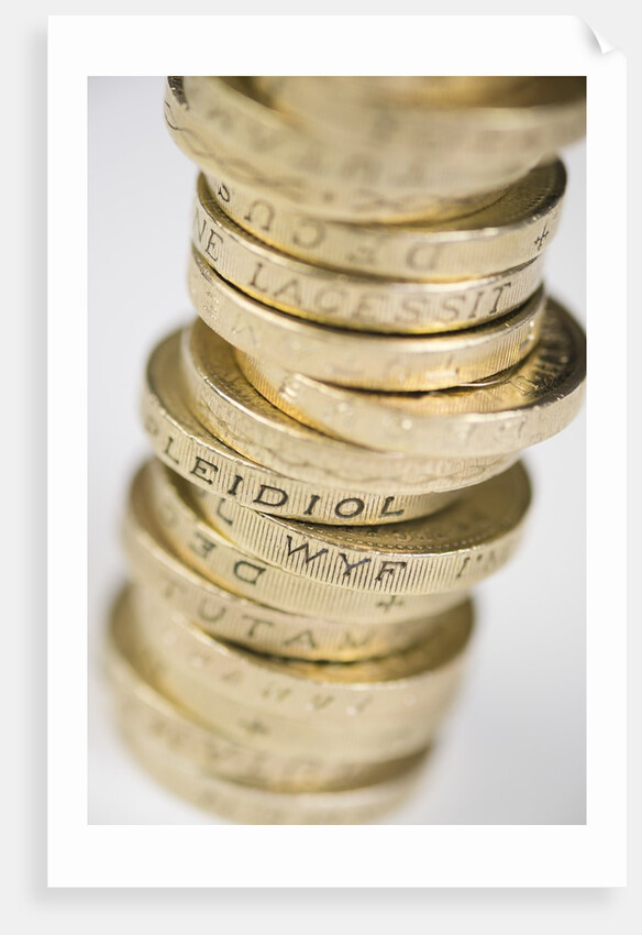 A pile of pound coins on a table by Anonymous