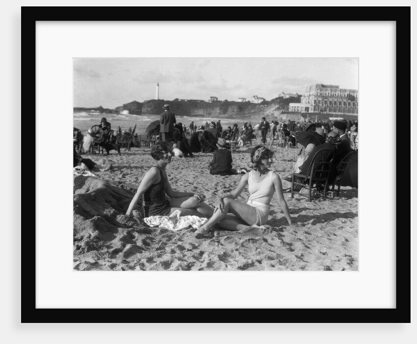 1920s two women sitting on the beach in bathing suits by Anonymous