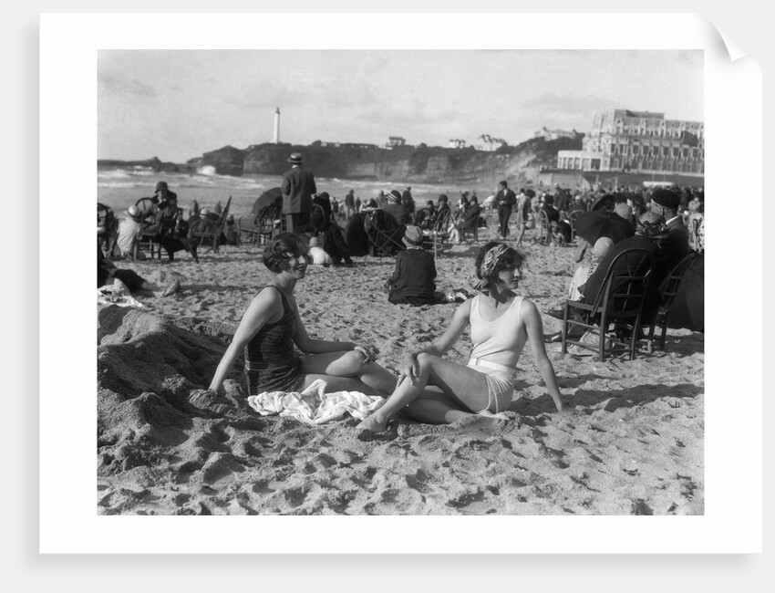 1920s two women sitting on the beach in bathing suits by Anonymous