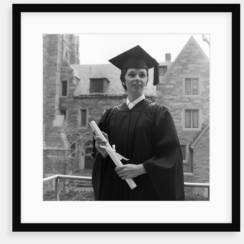 1950s smiling female graduate holding a diploma by Anonymous