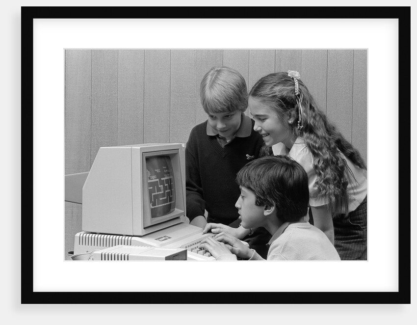 1980s boys and girl playing games on a computer by Anonymous