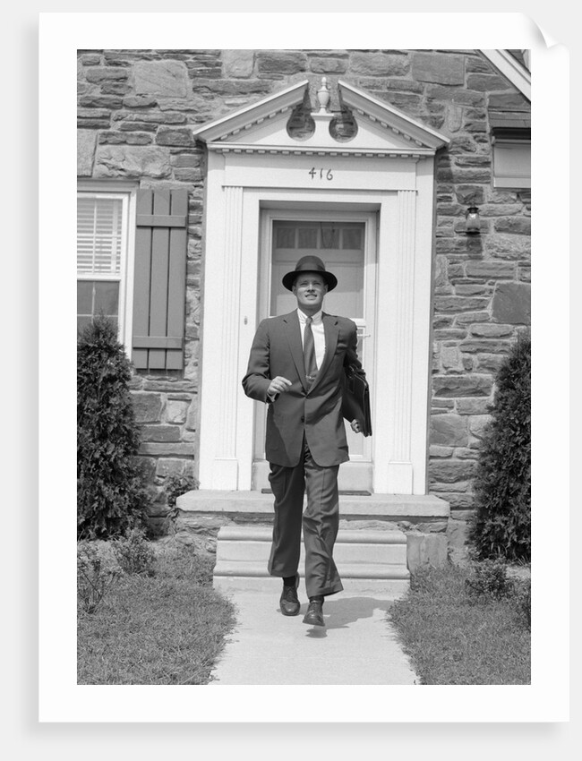1950s smiling businessman walking out the front door of his house by Anonymous