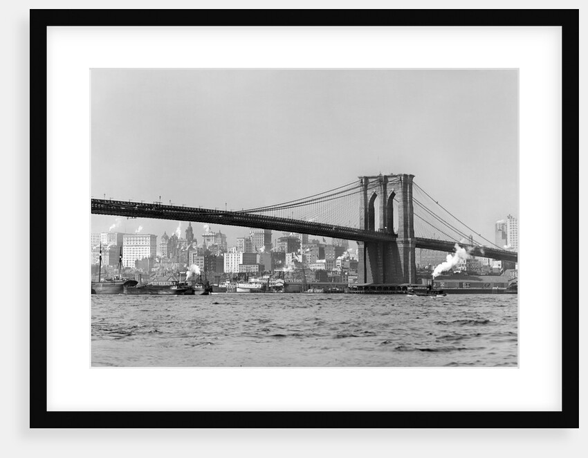 The Brooklyn Bridge spans the East River, ca. 1910. by Anonymous