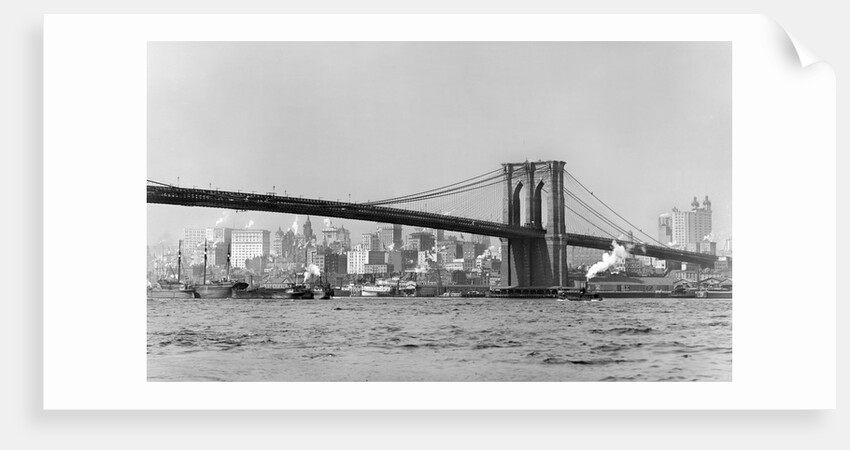 The Brooklyn Bridge spans the East River, ca. 1910. by Anonymous