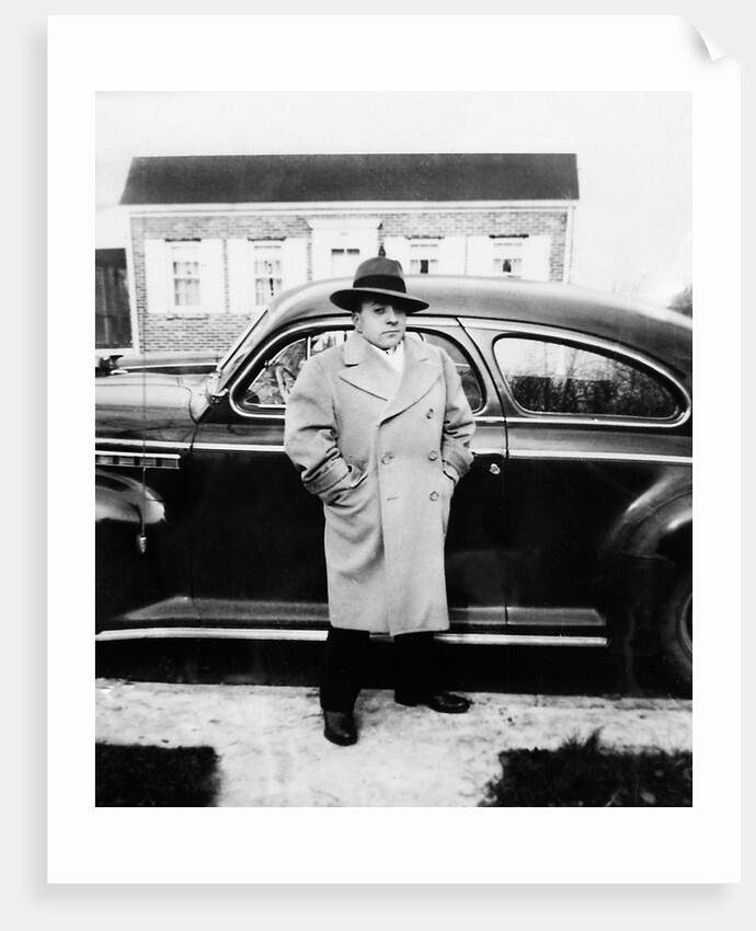 Mature man stands by his car, ca. 1942. by Anonymous