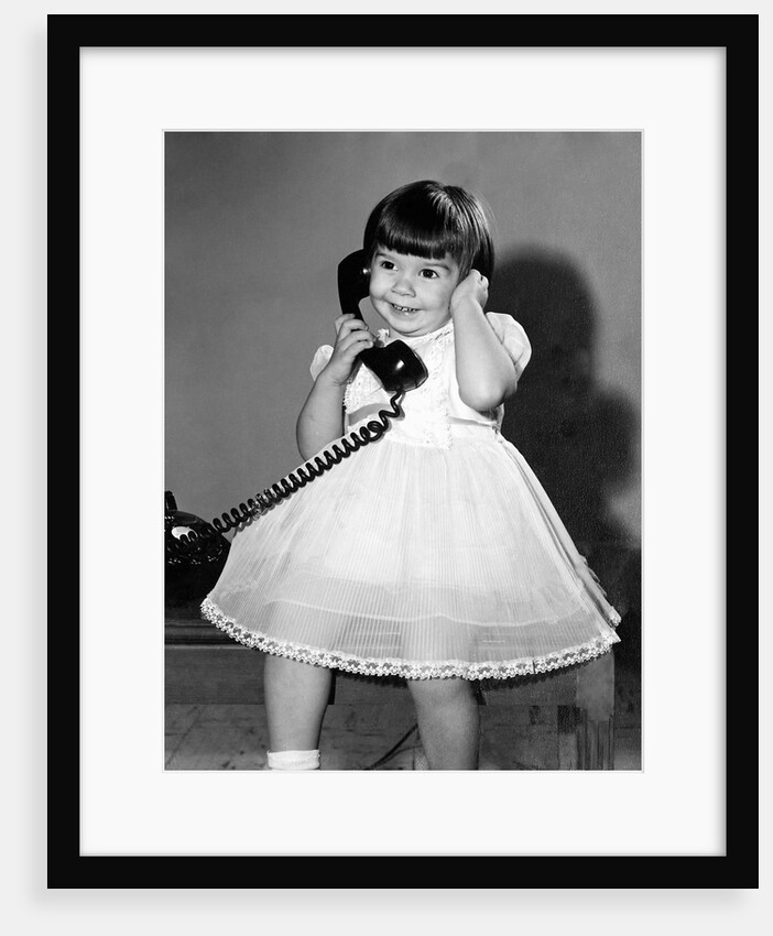 Young girl talks on the phone, ca. 1962. by Anonymous