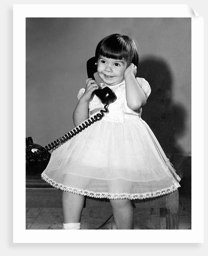Young girl talks on the phone, ca. 1962. by Anonymous