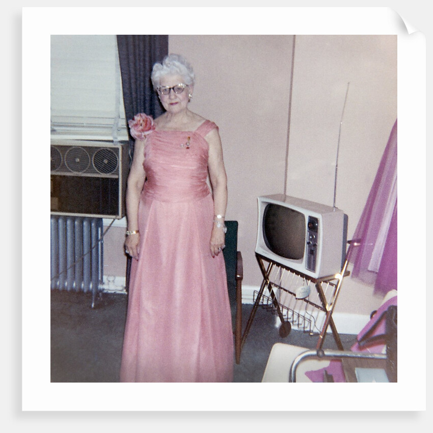 Grandma is all dressed up and standing next to a TV, ca. 1965 by Anonymous