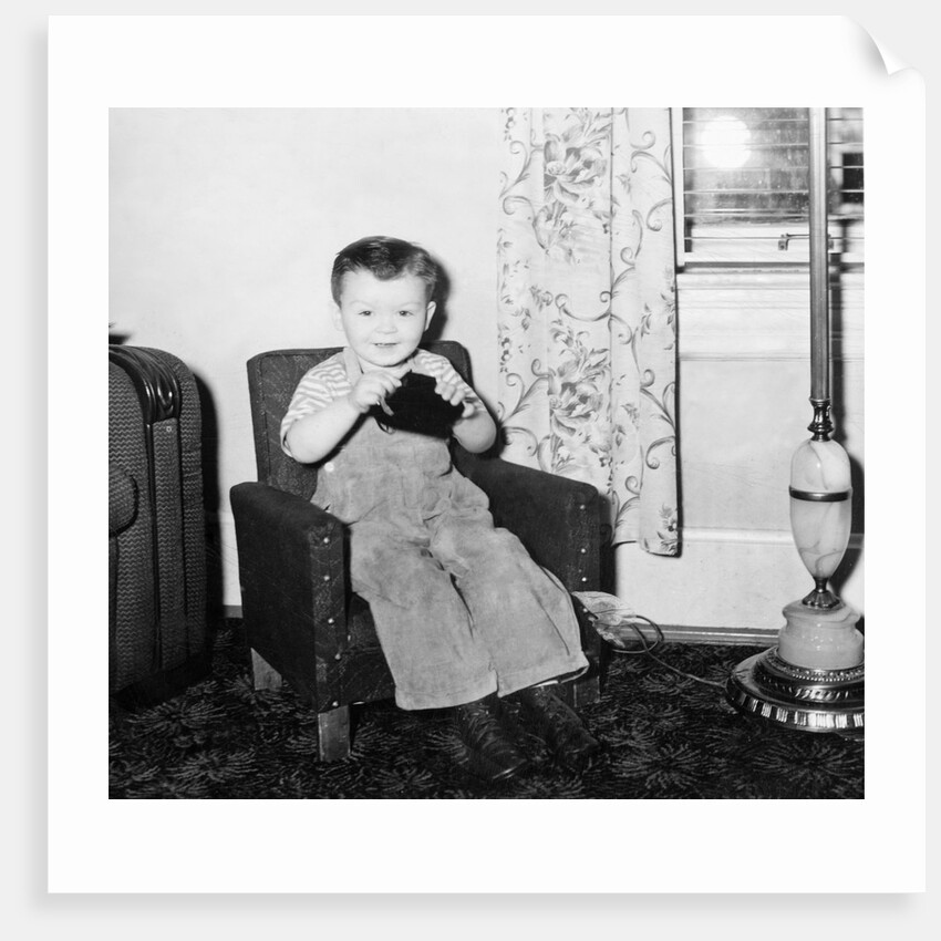 Young boy in his living room, ca. 1946. by Anonymous