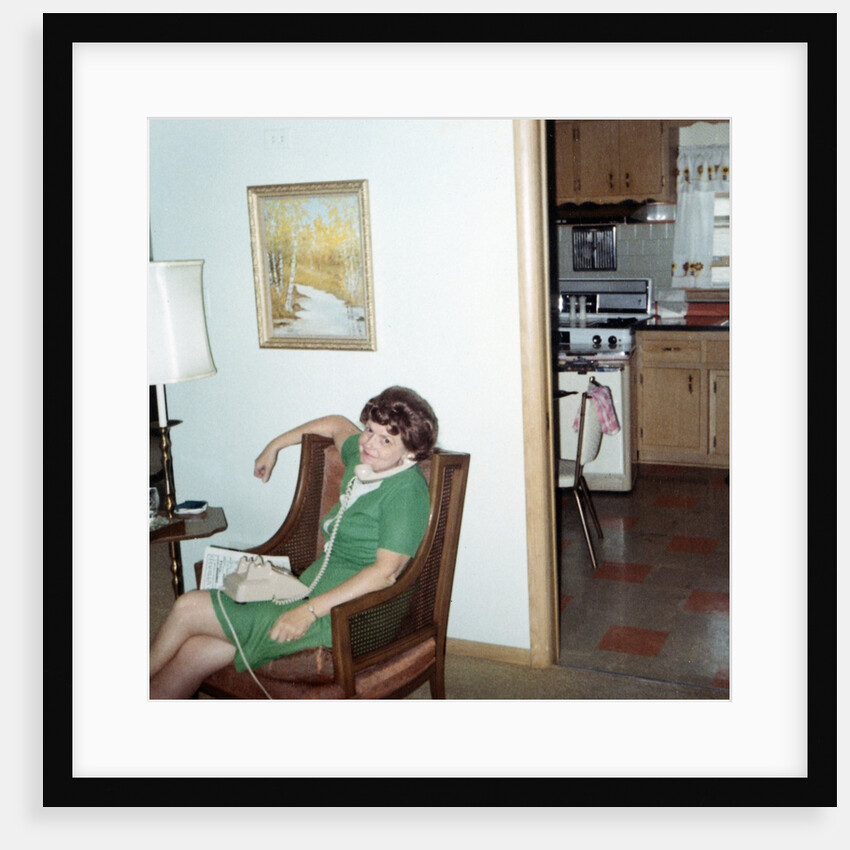 Mature woman on phone in her home, ca. 1970. by Anonymous