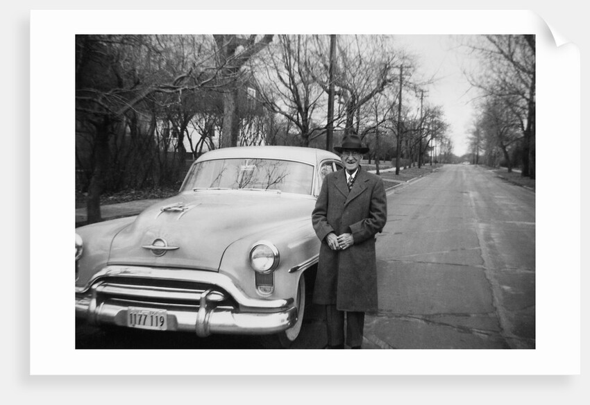 Senior man with his automobile on an Illinois street, ca. 1950. by Anonymous