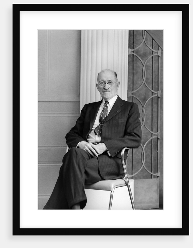 Senior man sits for a portrait in a chair, ca. 1948. by Anonymous