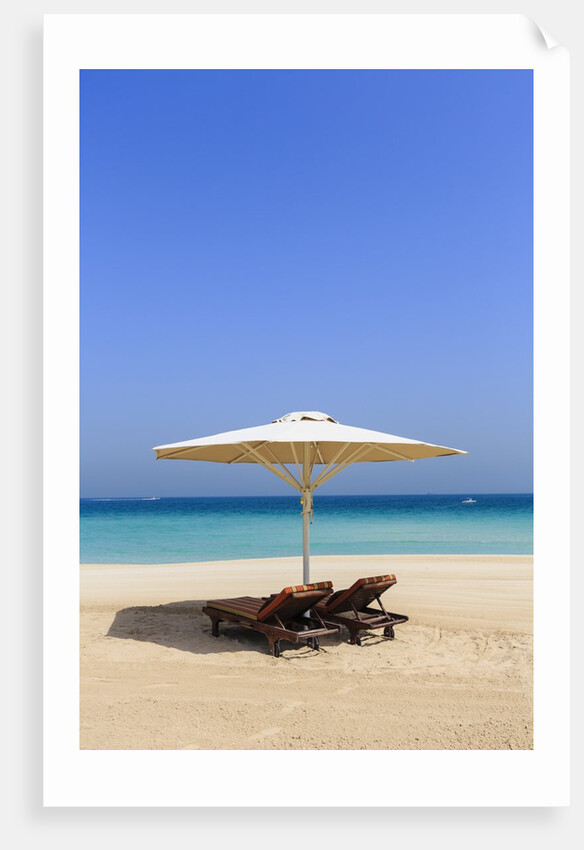 Parasol and recliner on the beach, Dubai by Anonymous