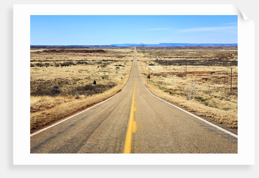 Long desert road stretching into the distance. by Anonymous