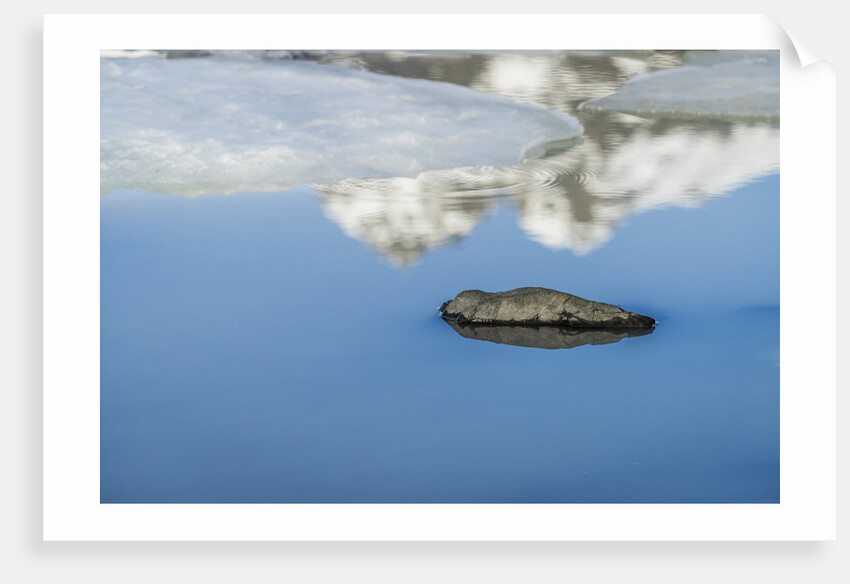 Rock with sky reflected in water. by Anonymous