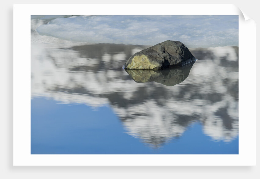 Rock with sky reflected in water. by Anonymous