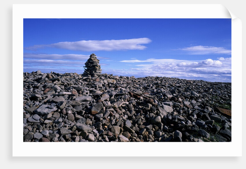 Stacked rock sculpture among rocky coastline. by Anonymous