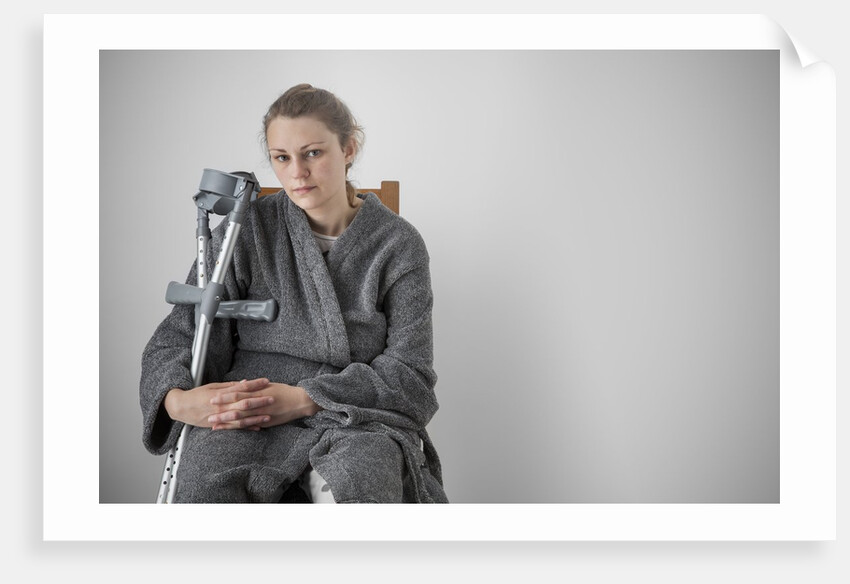 Woman seated with crutches by Anonymous