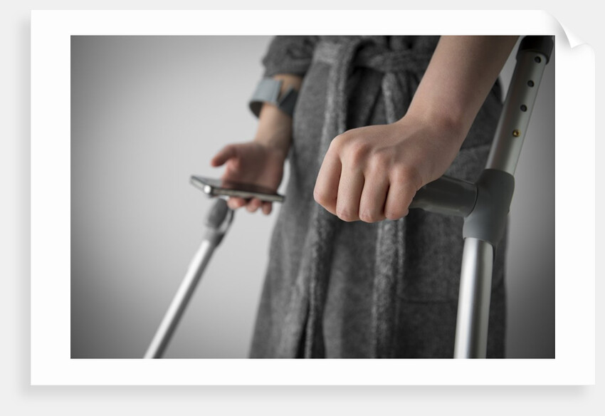 Person on crutches texting by Anonymous