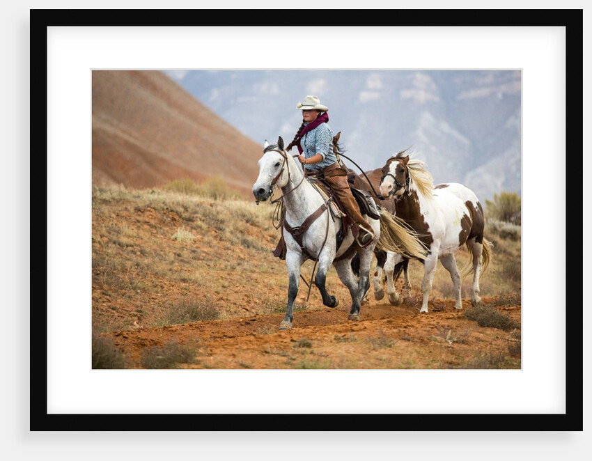 Cowgirl at Full Gallop with Horses in tow by Anonymous