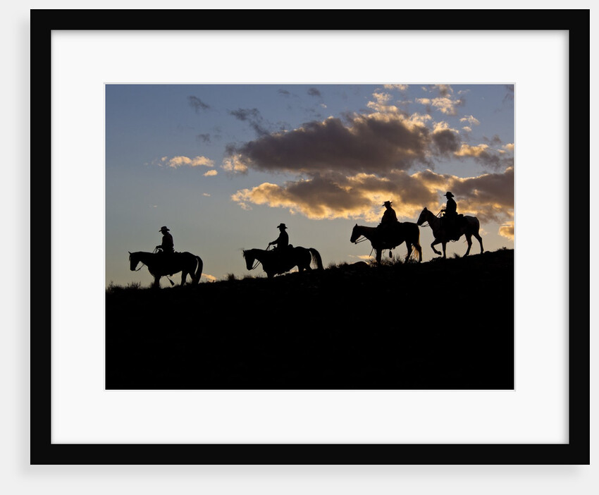 Cowboys in silhouette with sunset by Anonymous