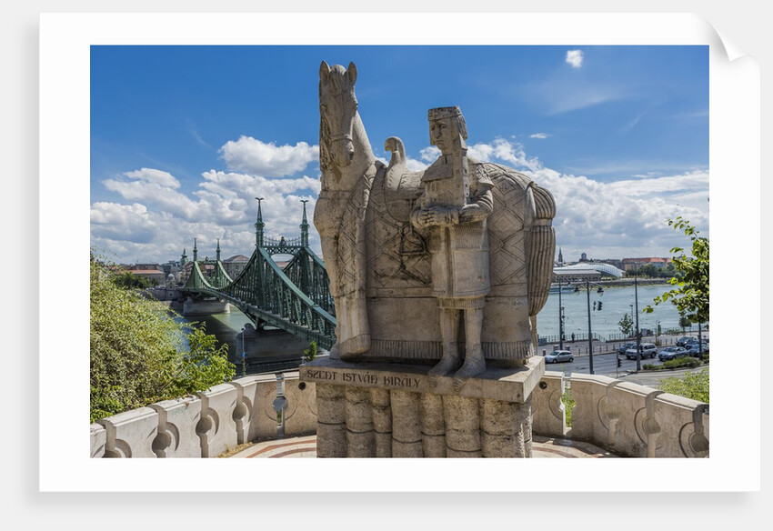Gellert Hill), the statue of Saint Stephen near the entrance of Sziklatemplom (Church by the Rock), on the left the Szabadsag hid (Liberty Bridge or Freedom Bridge) by Anonymous