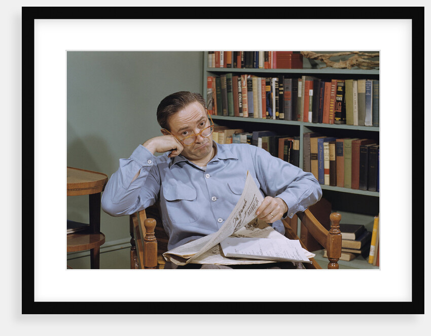 Man Holding Newspaper While Thinking by Anonymous