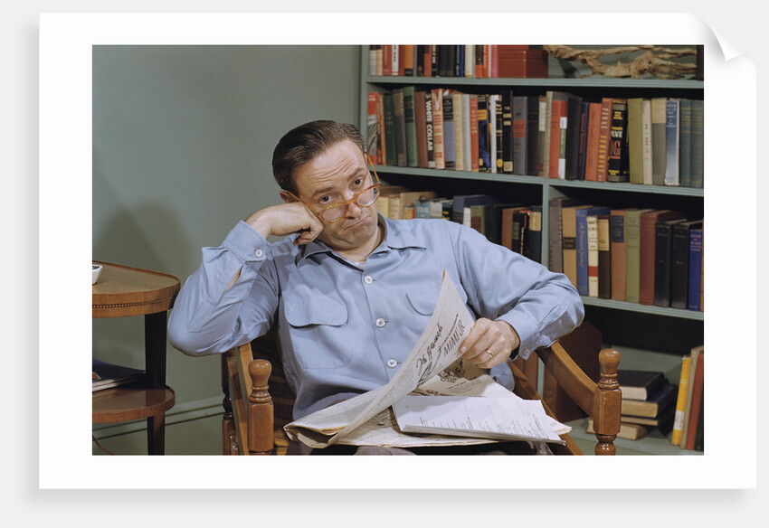 Man Holding Newspaper While Thinking by Anonymous