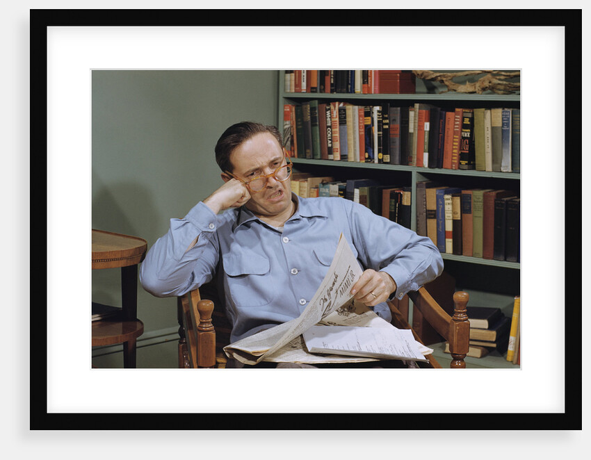 Man Holding Newspaper While Thinking by Anonymous