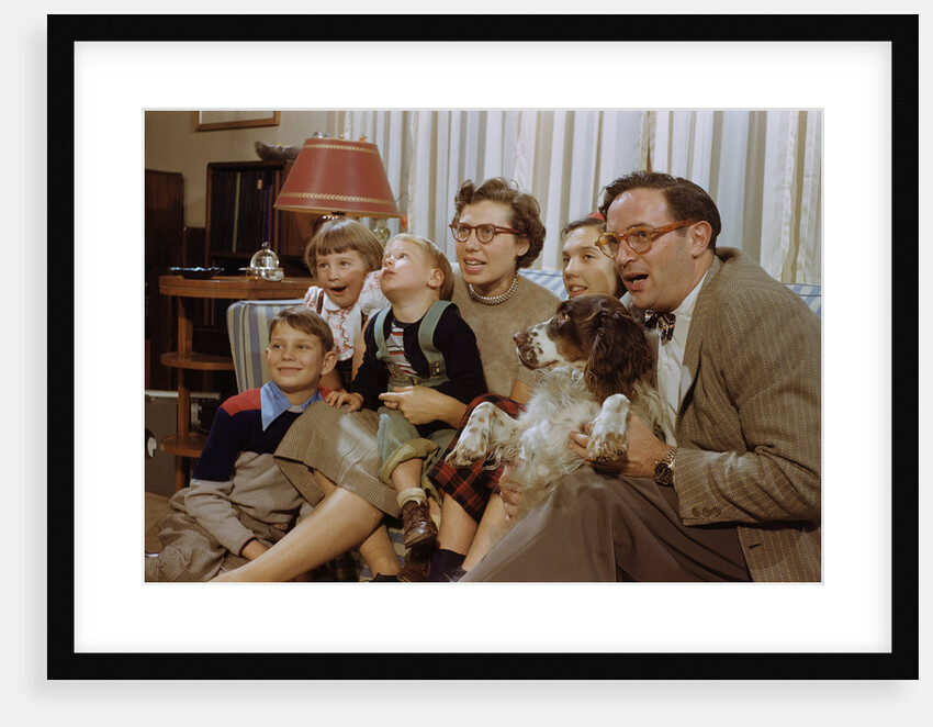 Family Sitting on Couch Together by Anonymous