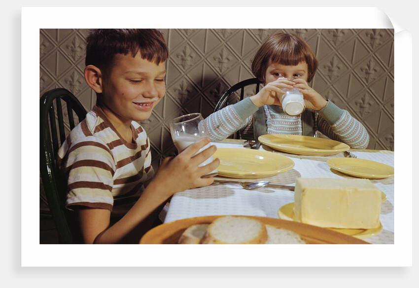 Children Drinking Milk at Dinner Table by Anonymous