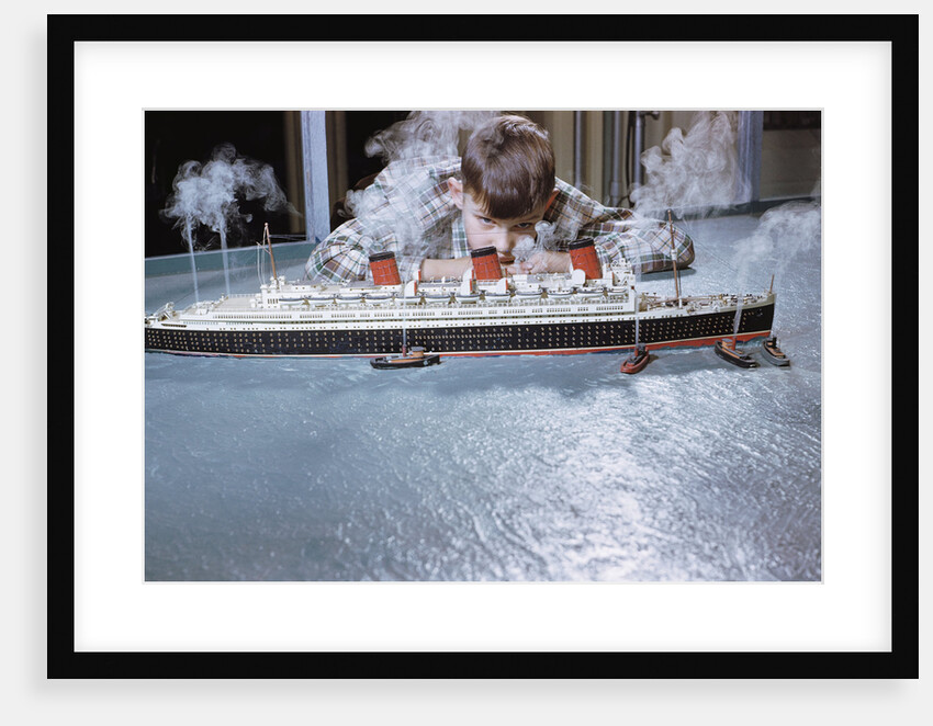 Boy Playing with Toy Ocean Liner by Anonymous