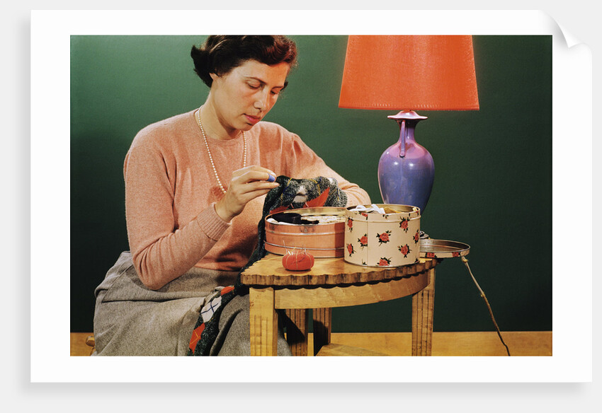 Woman Darning Socks by Anonymous