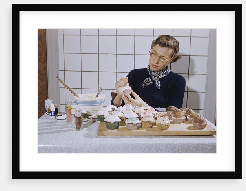 Woman Decorating Cup Cakes by Anonymous