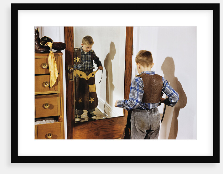 Boy Trying on Cowboy Duds by Anonymous