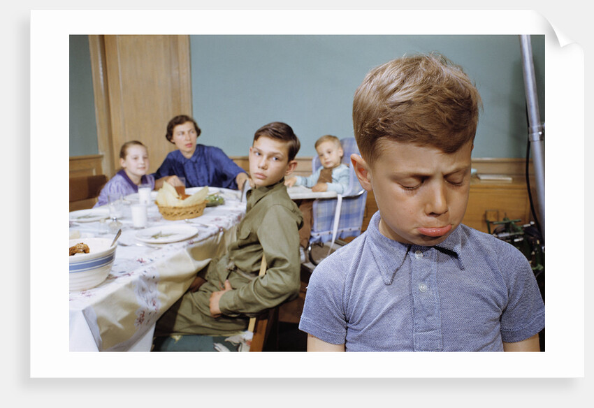 Boy Pouting near the Dinner Table by Anonymous