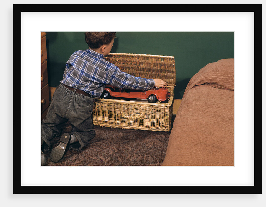 Boy Removing Fire Engine from Toy Chest by Anonymous