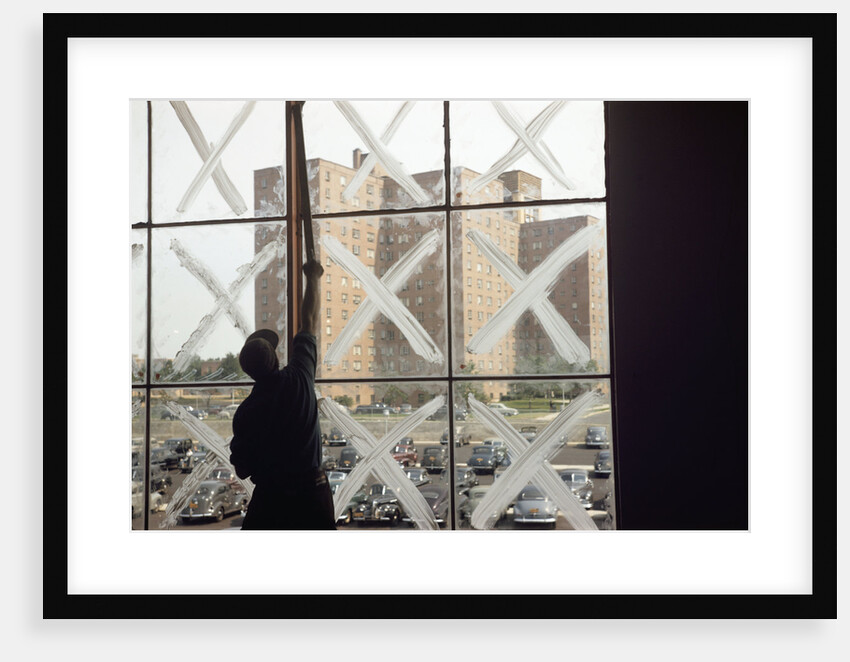 Man Cleaning Windows near Housing Project by Anonymous