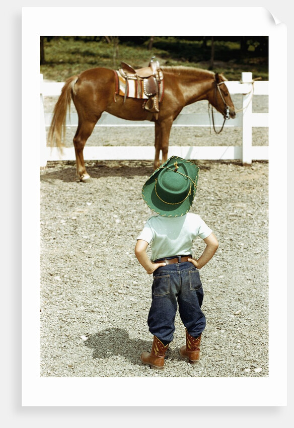 Young Cowboy Looking at Horse by Anonymous