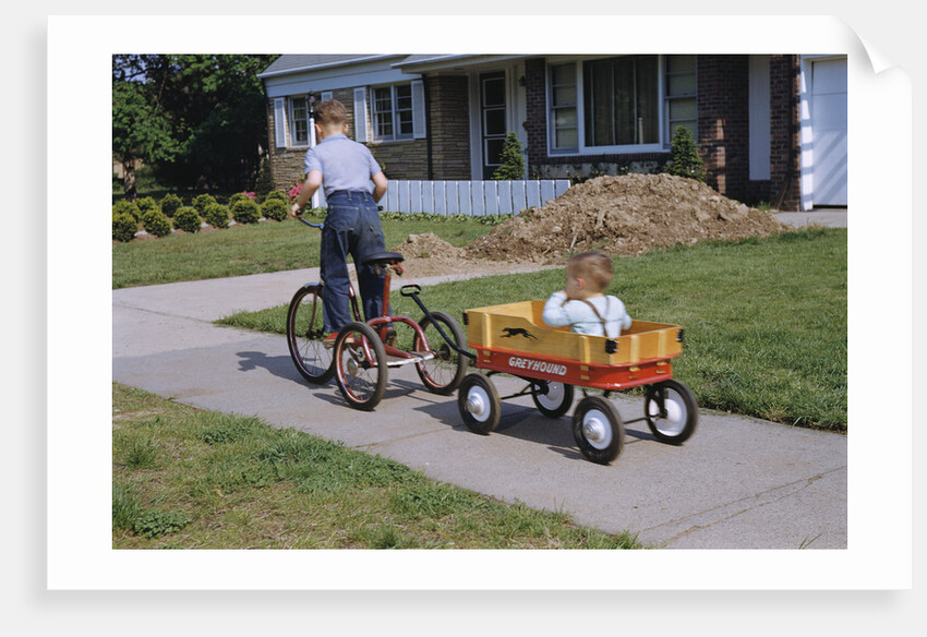 Boy Riding Tricycle and Towing Wagon by Anonymous