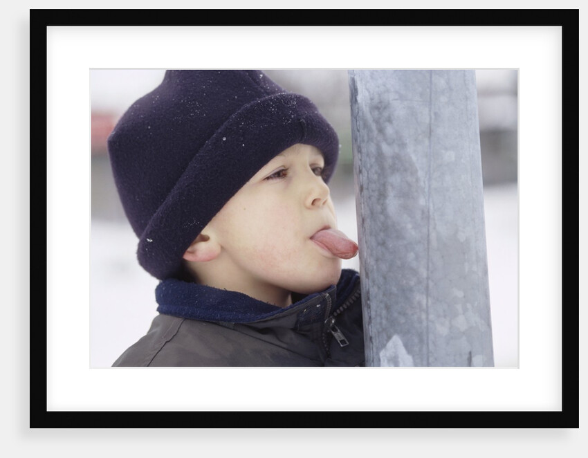 Boy Putting Tongue to Frozen Pole by Anonymous