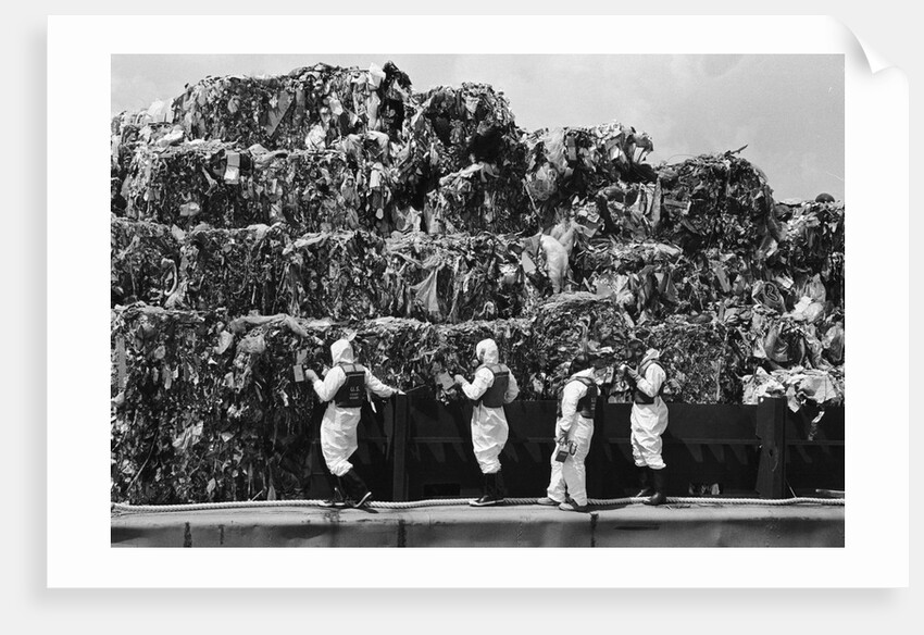 Workers Inspecting Garbage On Barge by Anonymous