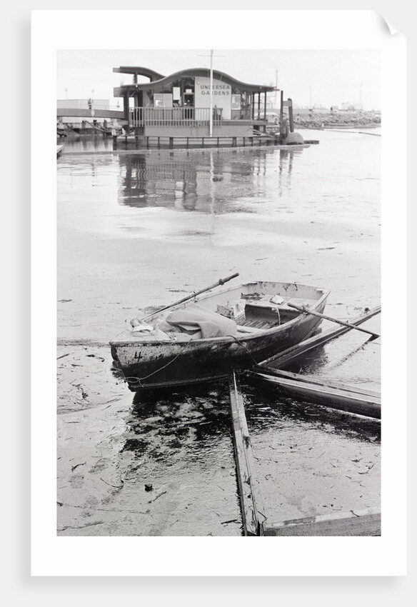 Oil-Slicked Boat Washed On Oiled Beach by Anonymous