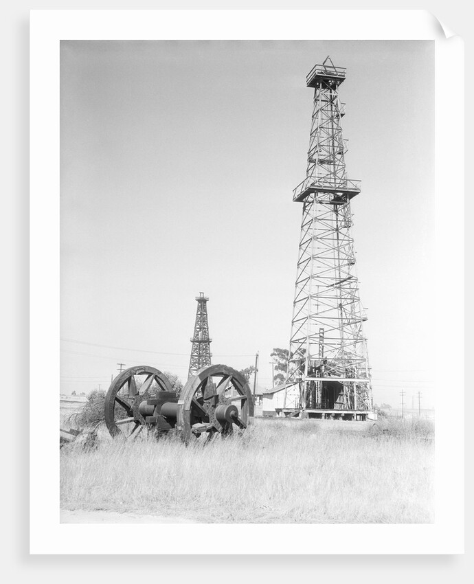 Oil Derricks In Field by Anonymous